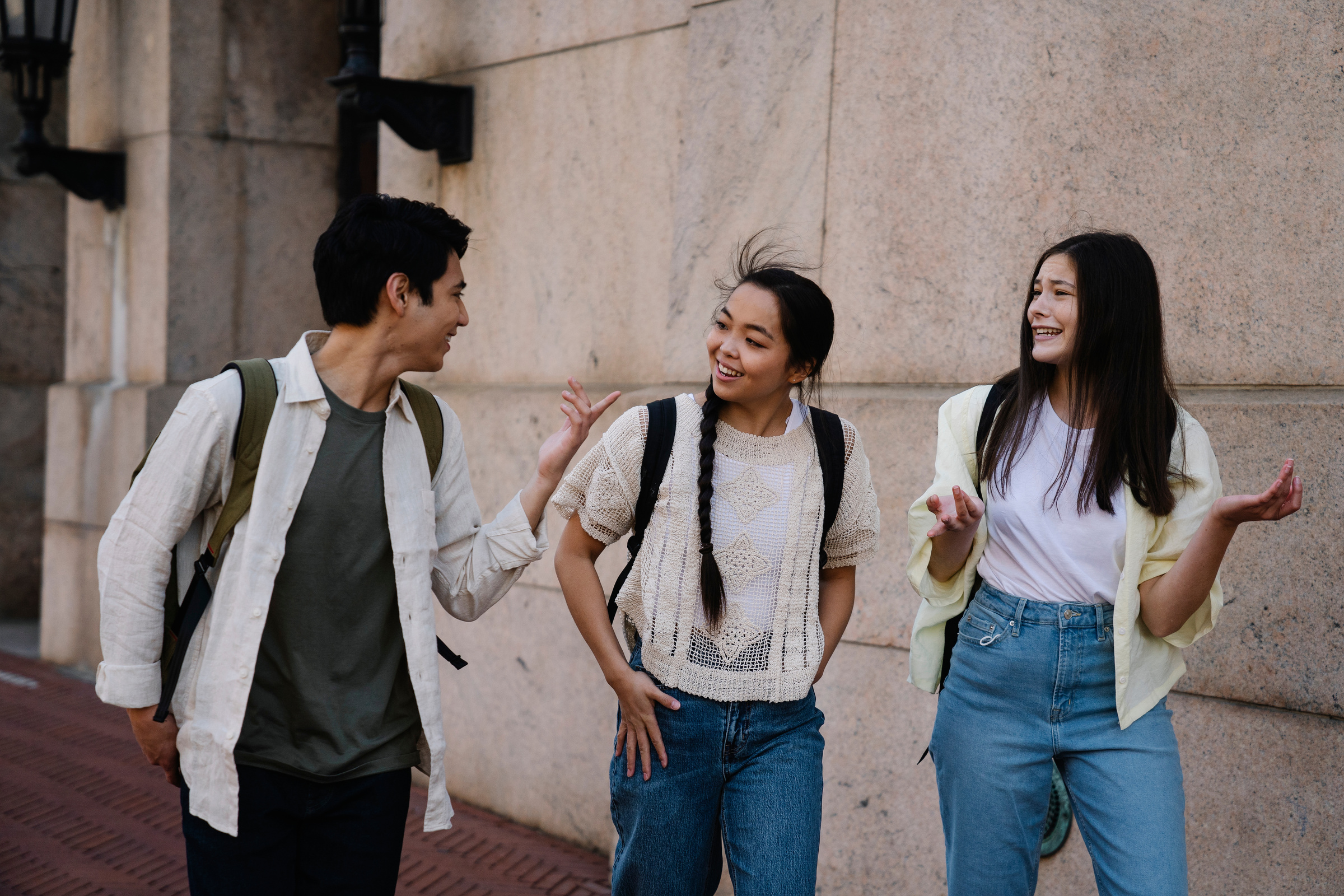 Photo of a Group of Friends Talking while Walking